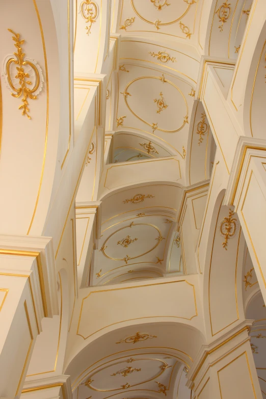 the ceiling inside a building with gold decorations