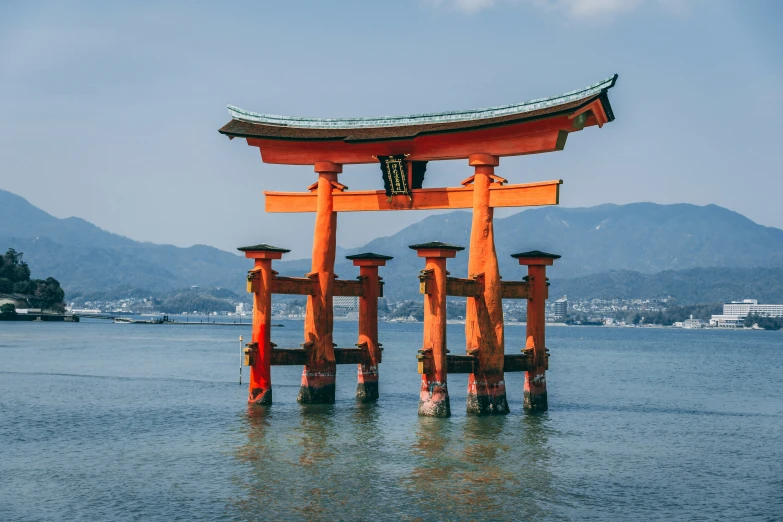 a big red structure sitting on top of a body of water