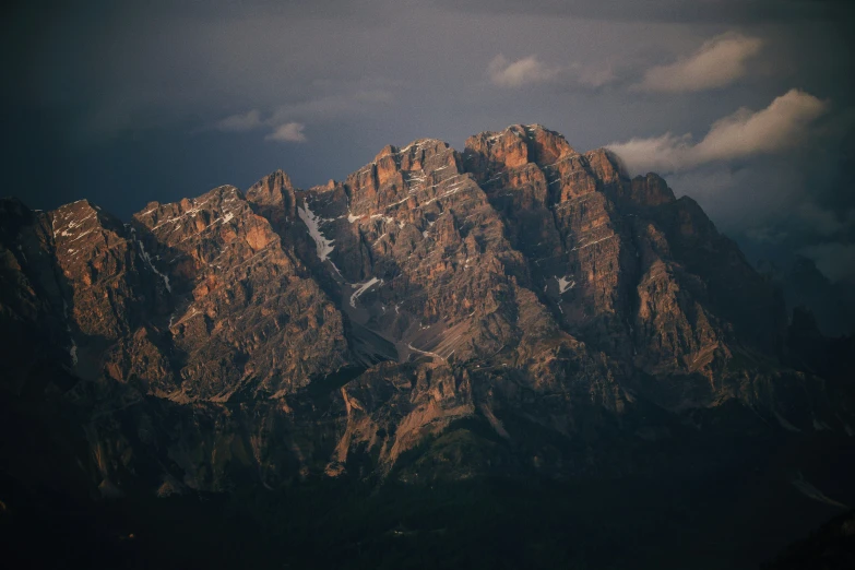 the summits of a mountain range under a cloudy sky