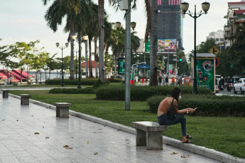 a man is sitting on a park bench