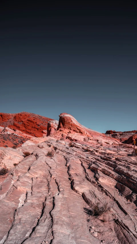 several small rocks in the desert with a single sky