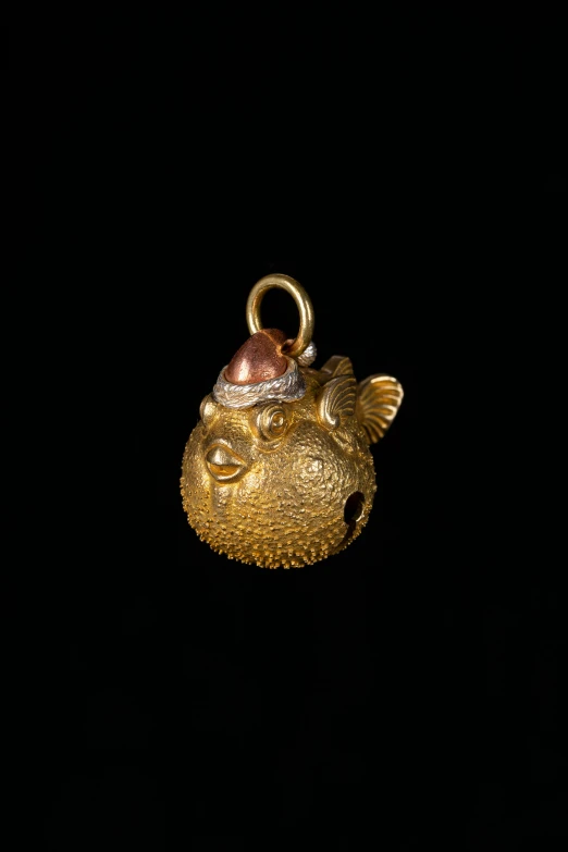 a gold and silver object with fish shaped decorations