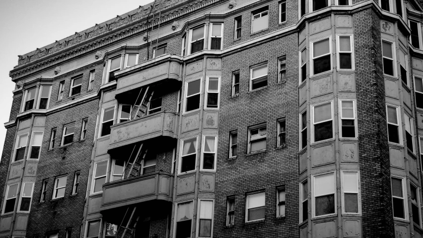 an old brick building has windows and a clock