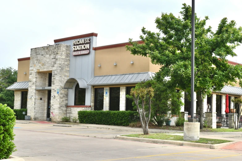 the exterior of a store with stone and metal accents