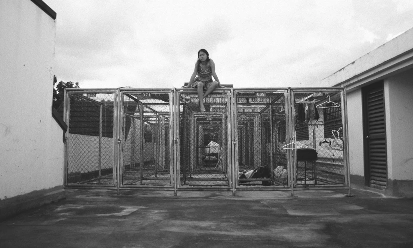 a woman is sitting on a door in an open area