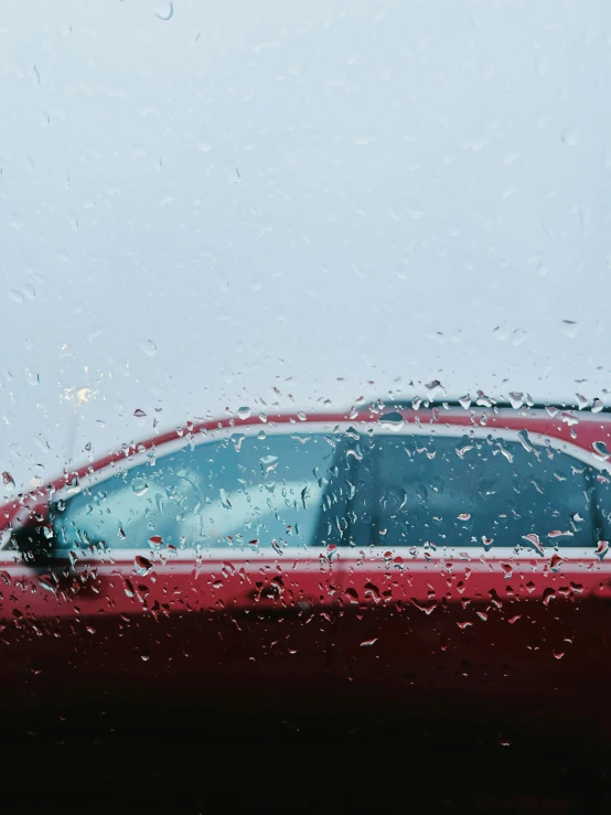 water drops are on the car window, while it's raining