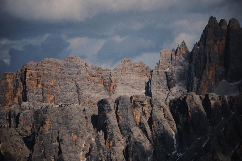 the mountain is covered in snow with rocky ridges