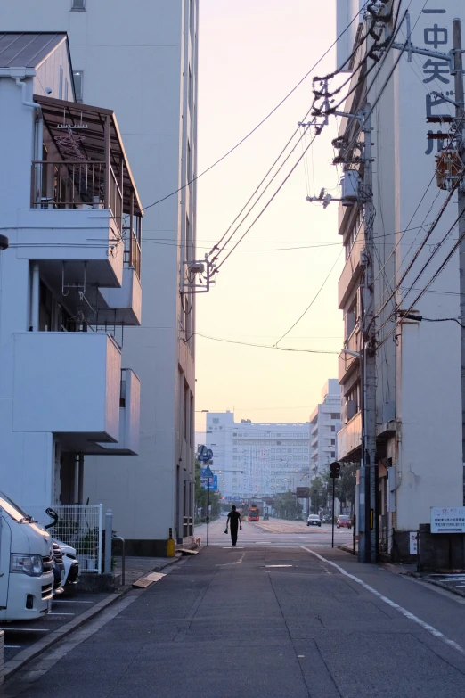 a person walks down a deserted street on an urban street