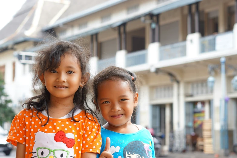 the two girls are standing together next to each other