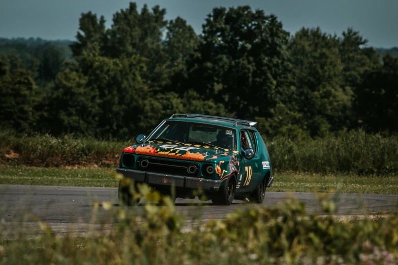 a car with green paint and design driving in the street