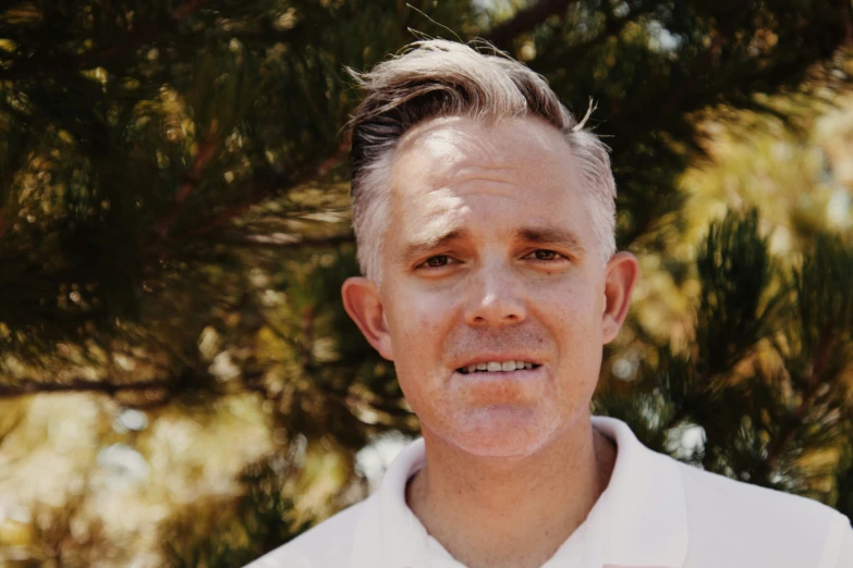 a close - up of a man wearing a white shirt and tie