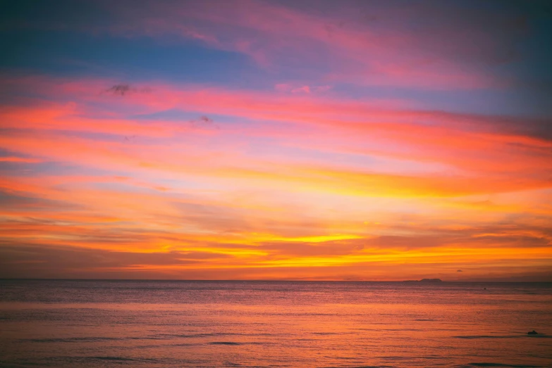 some pretty clouds and a colorful sky on a beach