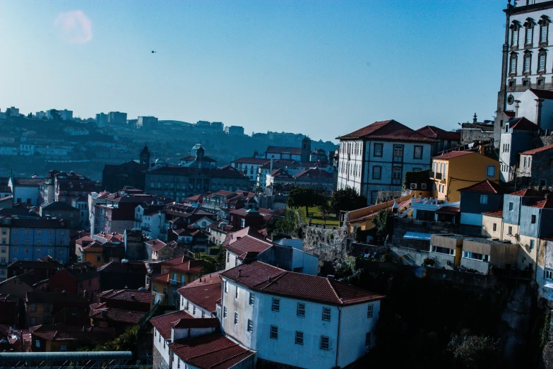 buildings on the side of a hill near a tall building