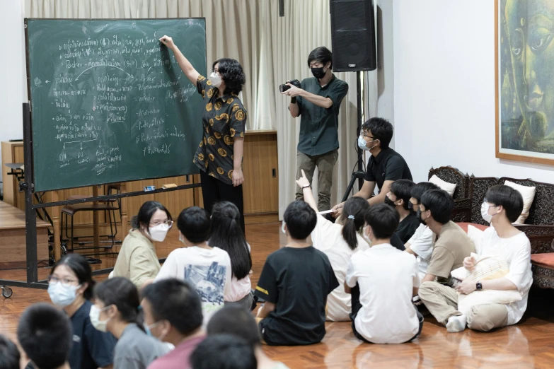 students in the classroom during a lesson on a blackboard