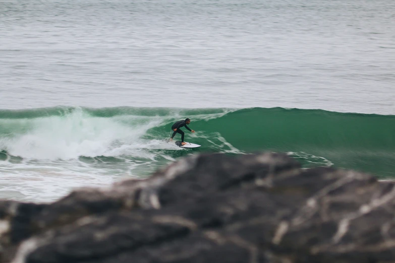 there is a male surfer that is riding the waves