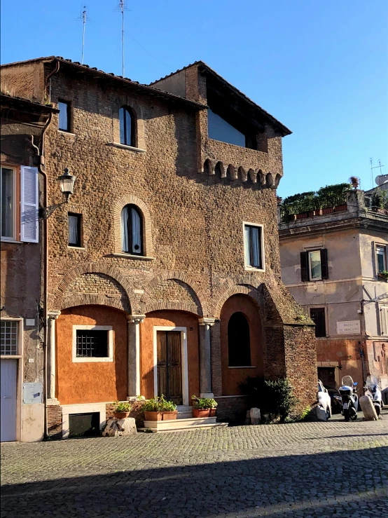 old stone brick building in the street of an italian city