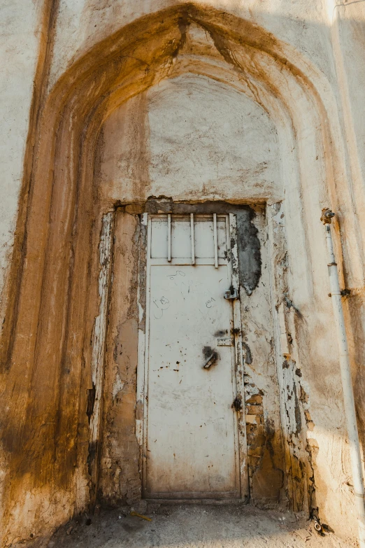 a dirty door that looks like it is in the middle of nowhere