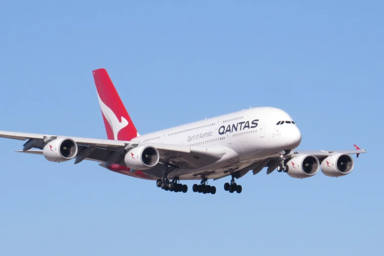 a huge jumbo jet plane flies in the blue sky