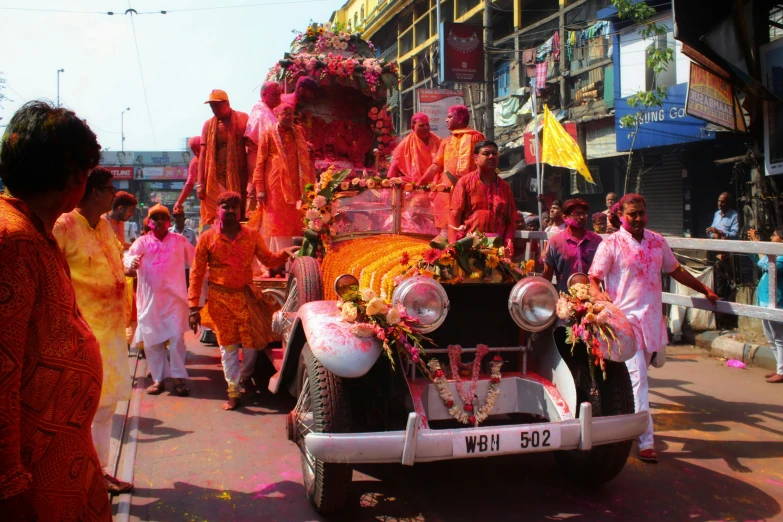 a decorated cart with people standing in the street