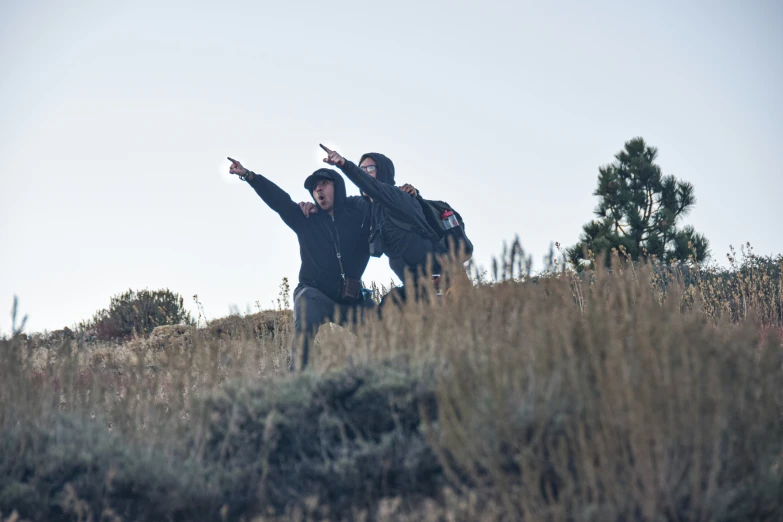 two people that are reaching out their arms