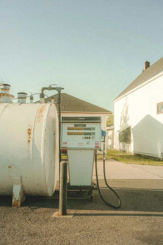 a propane tank is charging next to a large gas station