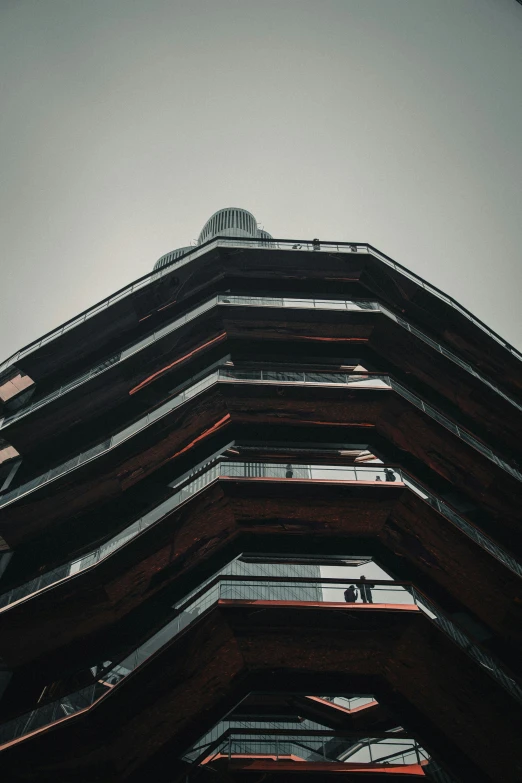 an upward view of a tall building made from brown brick