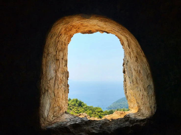 an image of a view through a stone window