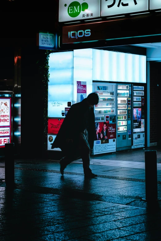 a person in silhouette walking on a street