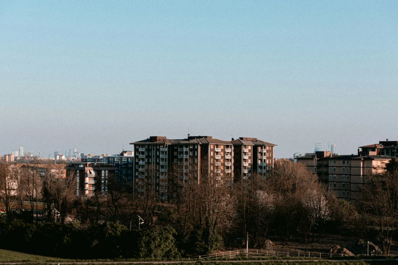 a large building near the top of some trees and buildings