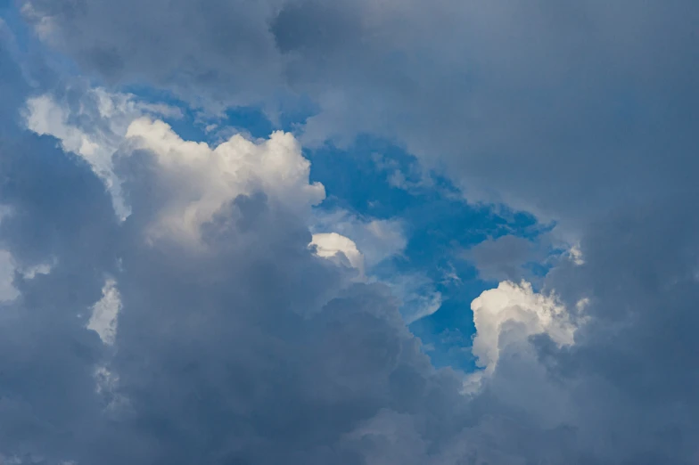 an airplane flying in a cloudy sky