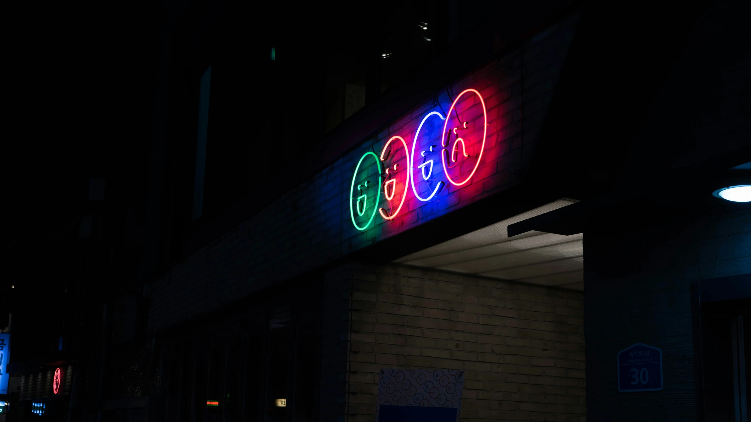 a neon sign on the side of a building