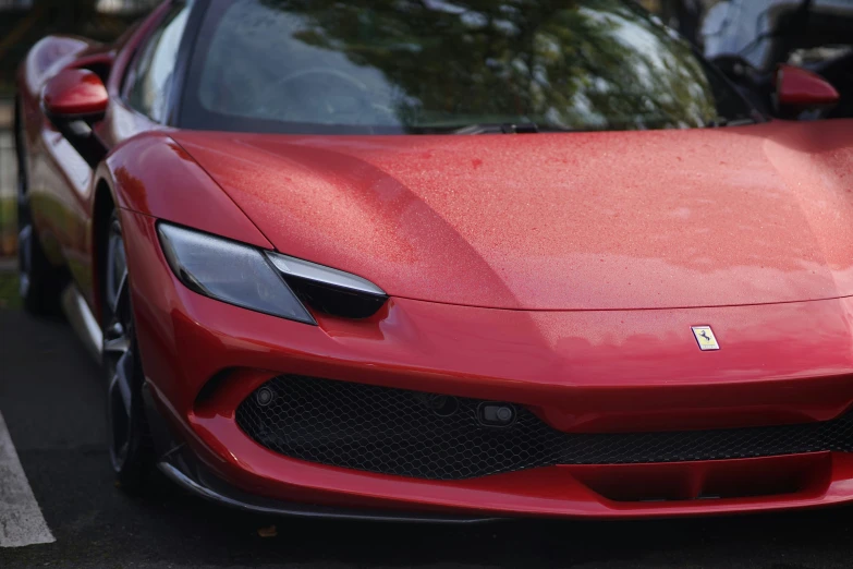 a ferrari, painted red with the emblem red diamond