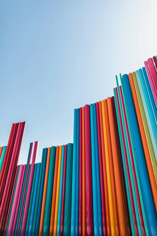 brightly colored plastic tubes with sky in background