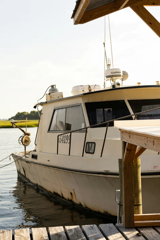 there is a boat that is docked next to the dock