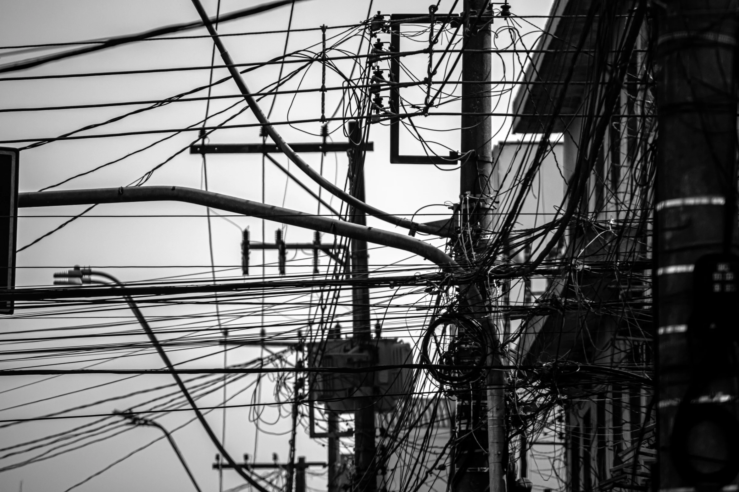 power lines and wires in the air above an intersection