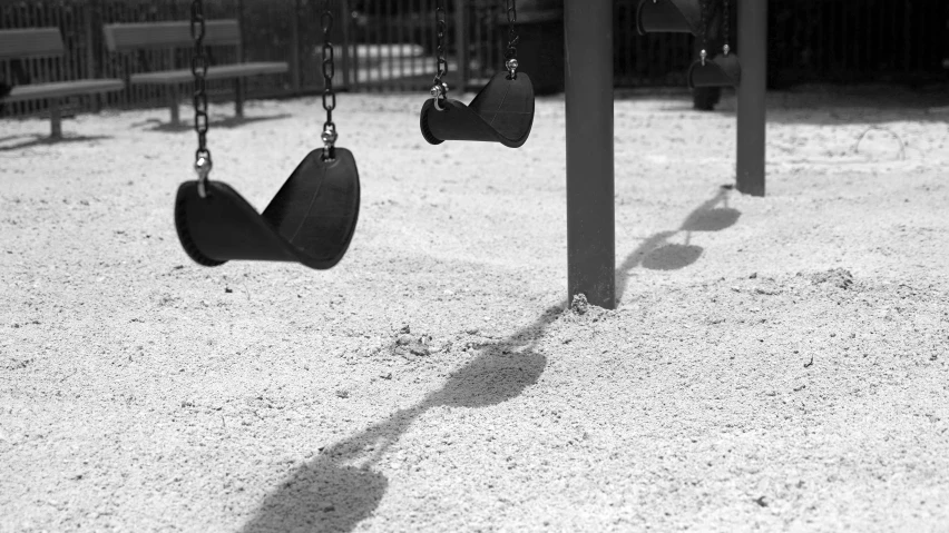 swings that are in a sandy park