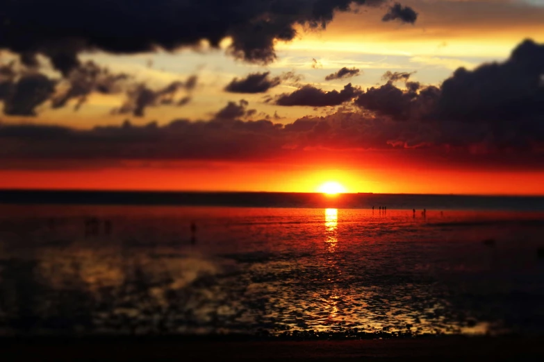 a sunset and clouds reflecting off the water