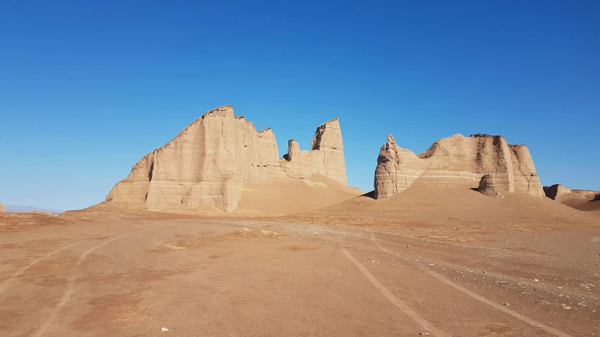 sand formations in the desert against blue skies