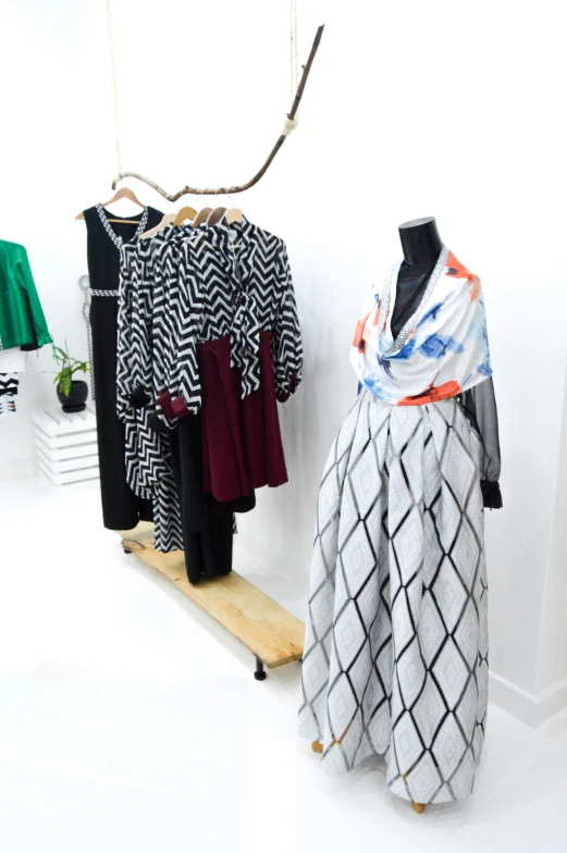 a display of ladies'clothing on wooden stands