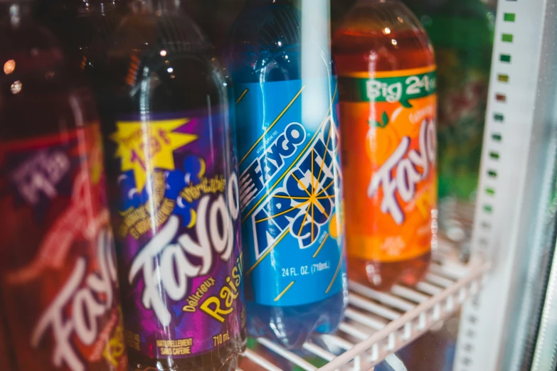 some soda bottles that are in the fridge