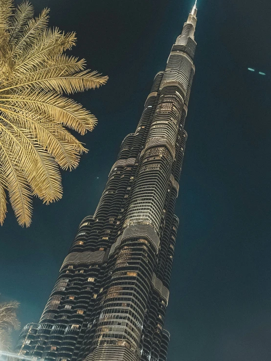 the burj building with golden leaves is surrounded by other tall buildings