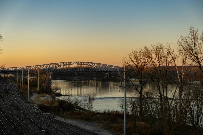 a train is crossing the track to cross the bridge over the water