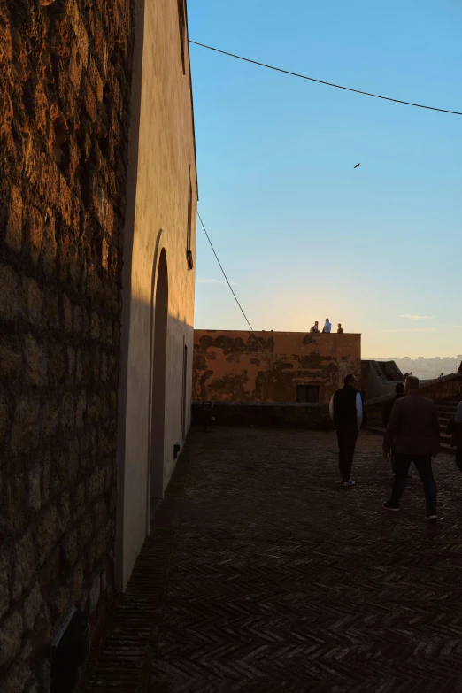 several people are walking up some steps towards a building