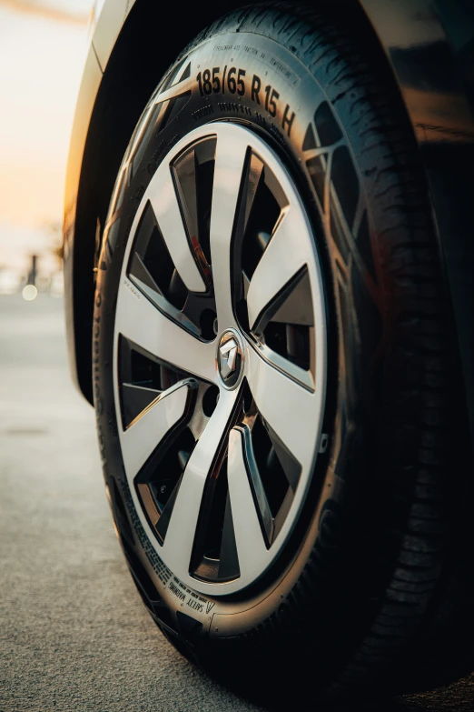 the tire of a car sits in a parking lot