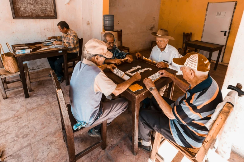 three people play chess together in a building