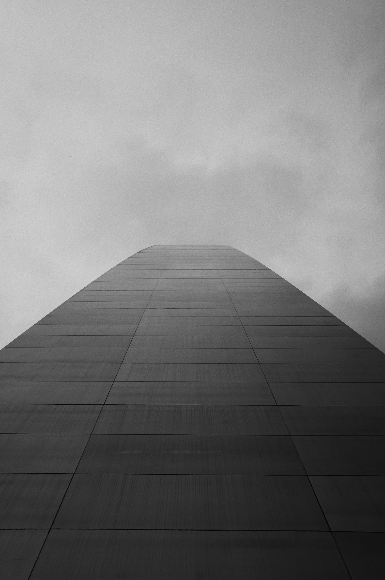 a large building is shown against a cloudy sky