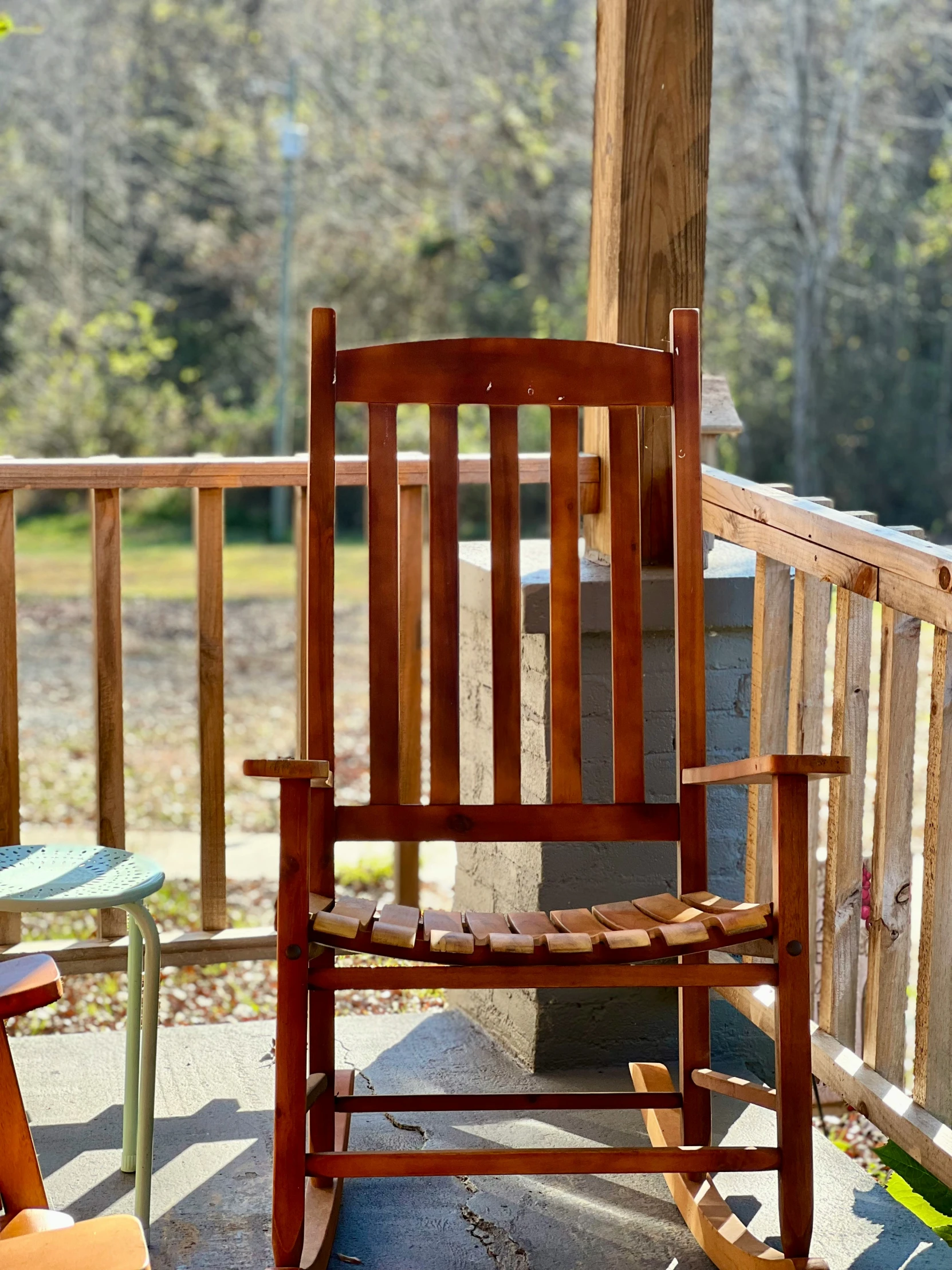 an old rocking chair sitting outside by the fire pit