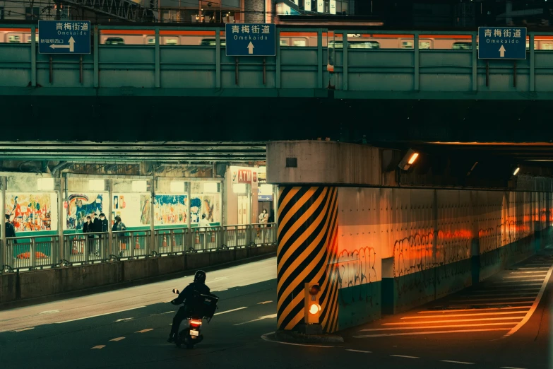 a motorcycle riding on the highway past a tunnel