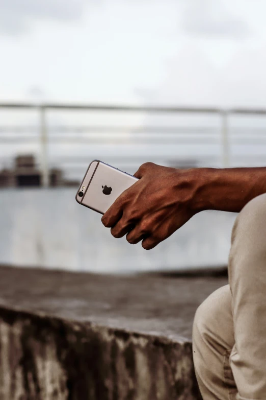 man with his phone up with the top of his pants exposed