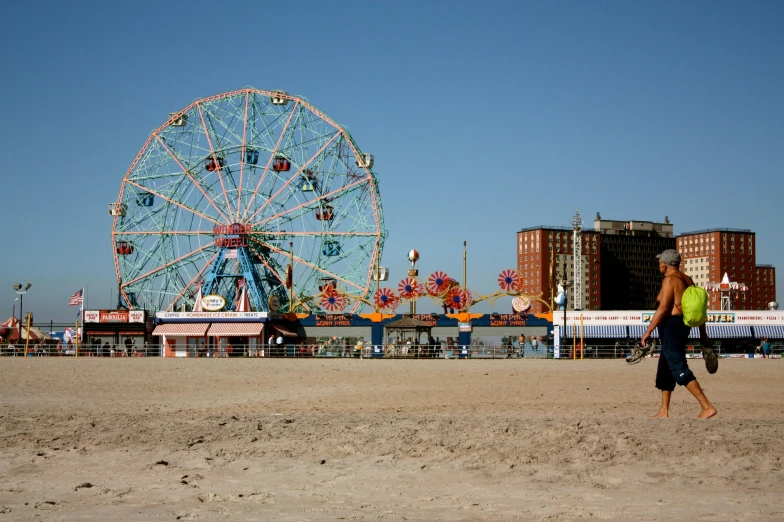 a ferris wheel next to the sand at an amut park